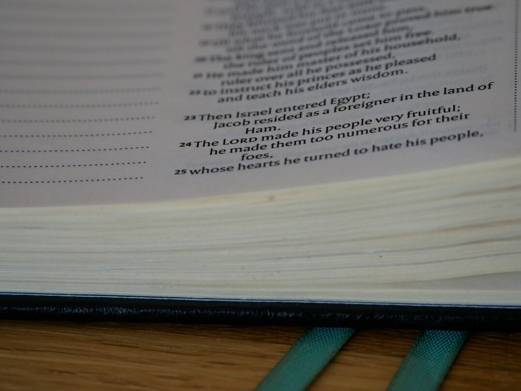 Typed manuscript pages with pencil notes on a wooden desk
