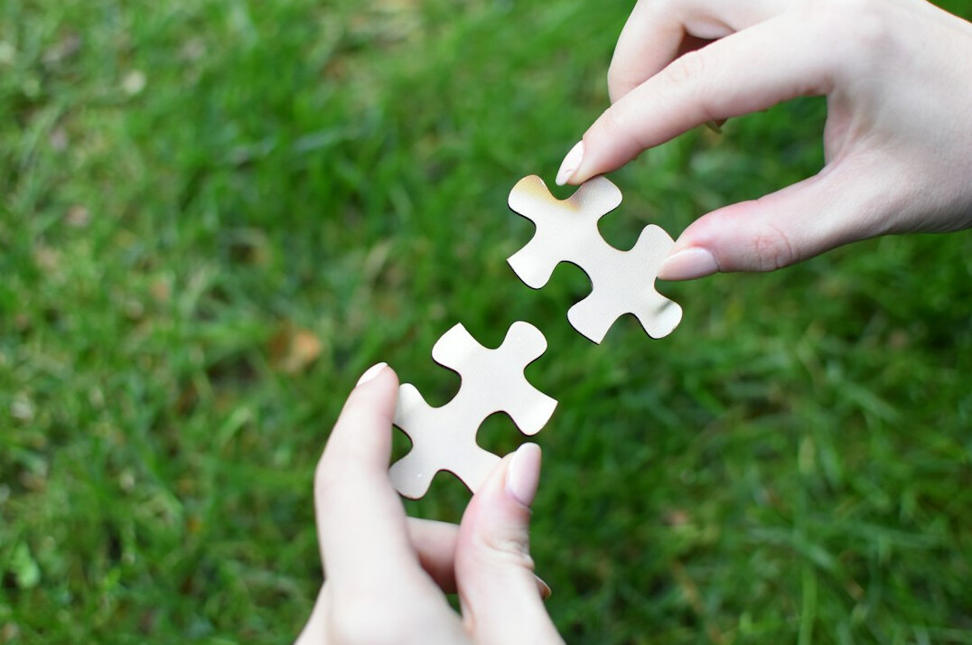 person solving jigsaw puzzle