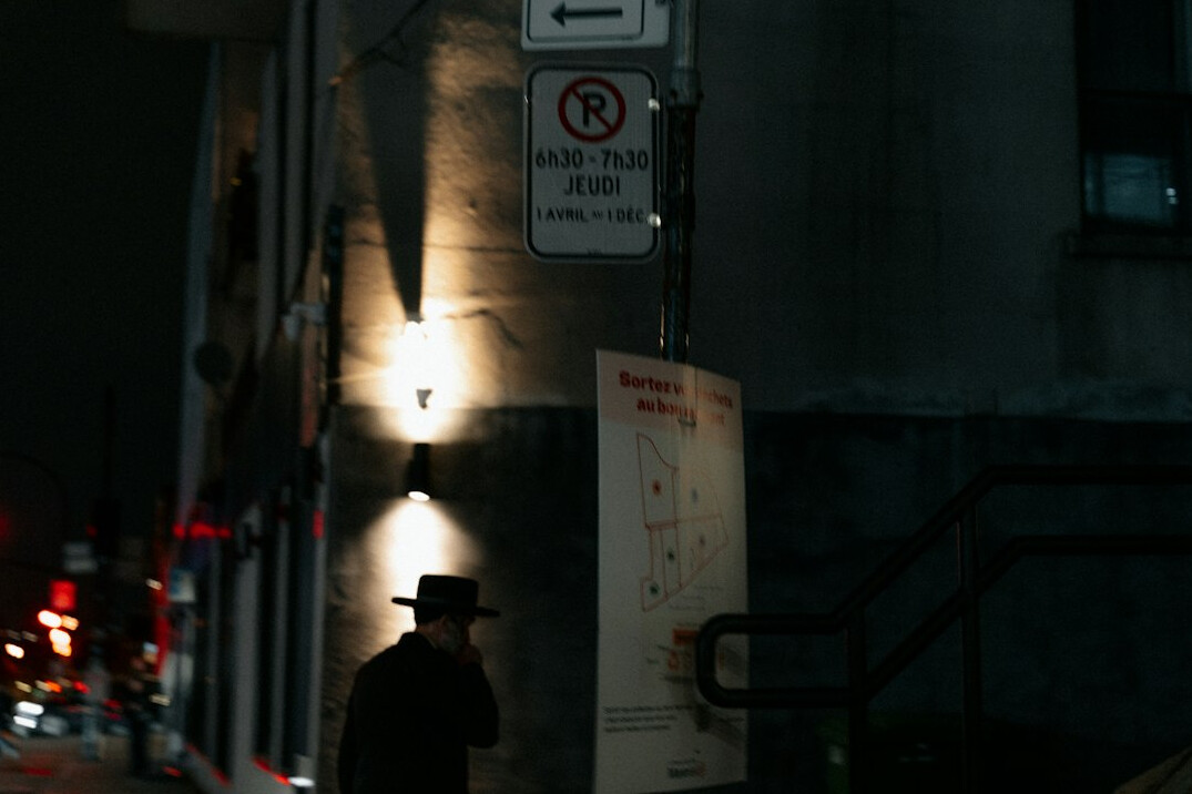 detective walking city street at night